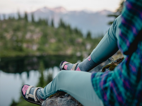 Hiker sitting on rock wearing Cloudline socks