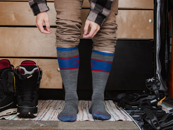 Snowboarder getting ready for the hill wearing Cloudline socks