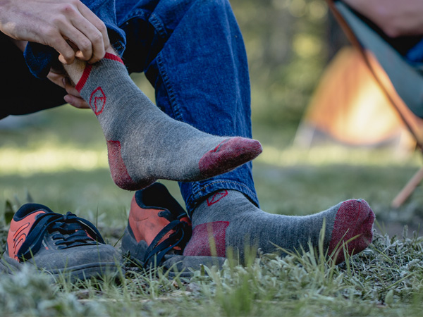 Camper pulling on Cloudline socks.