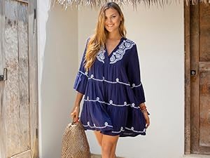 Woman in front of a door wearing a blue and white tie dye spaghetti strap beach dress cover up