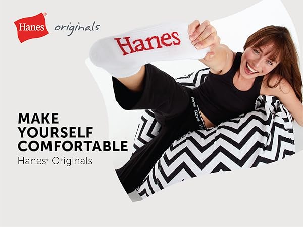 smiling model wearing Hanes Originals black Comfywear set white sock red Hanes logo