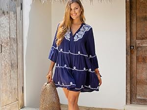 Woman in front of a door wearing a blue and white tie dye spaghetti strap beach dress cover up