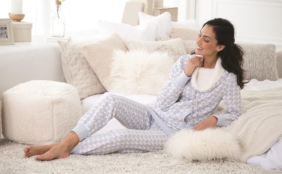 Woman in shearling pajamas on white couch